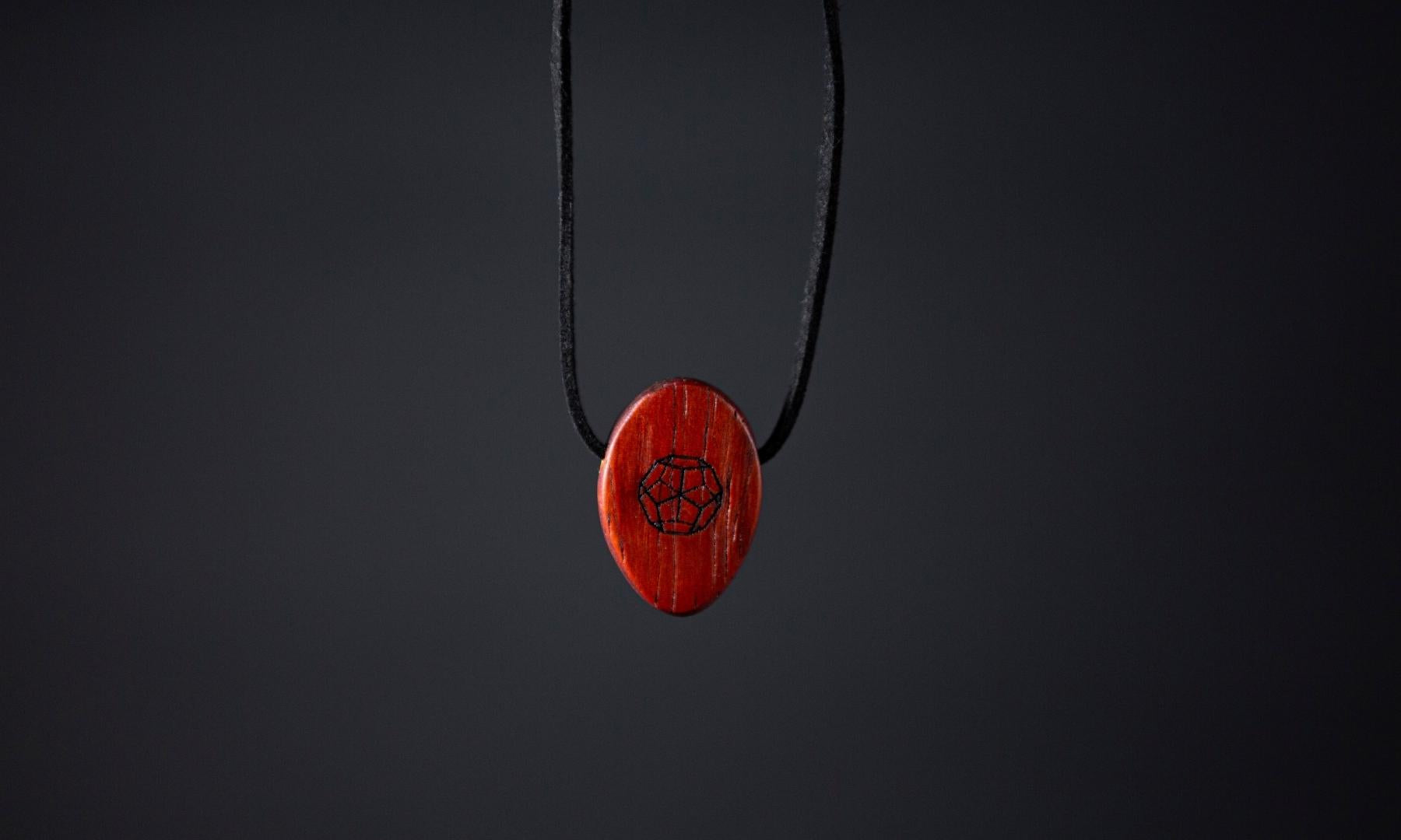 Padauk Deca Omnia Radiation Balancer Pendant on black