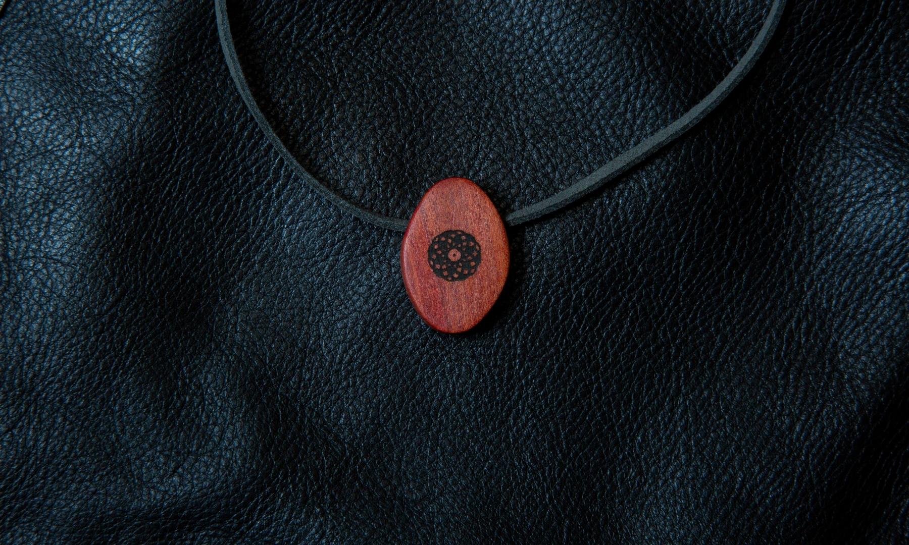 Torus Design Pendant in Pink Ivory black background