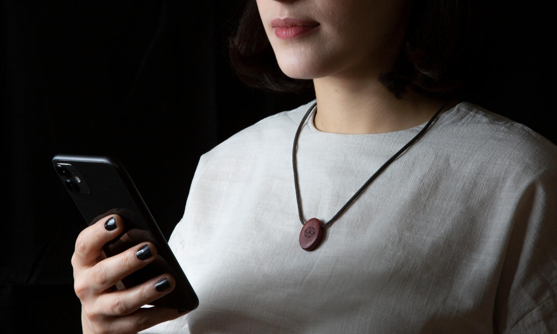 Omnia Radiation Balancer Pendant in Pink Ivory Deca design on shirt