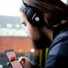 Man with headphones and Omnia Radiation Balancer sticker