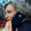 Lady with Omnia Radiation Balancer 5G sticker on phone